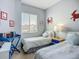 Bright bedroom with two twin beds, cheery nautical decor, and a sunlit window view at 6059 Bahia Del Mar Blvd # 235, St Petersburg, FL 33715