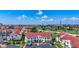 Exterior view of white condos with red roofs and landscaping, as well as a parking lot at 6059 Bahia Del Mar Blvd # 235, St Petersburg, FL 33715