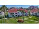 Beautiful condo building with red tile roof surrounded by lush tropical landscaping at 6059 Bahia Del Mar Blvd # 235, St Petersburg, FL 33715