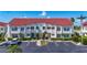 Charming two-story condo featuring a red tile roof, well-maintained landscaping, and convenient parking at 6059 Bahia Del Mar Blvd # 235, St Petersburg, FL 33715
