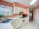 Bright kitchen with white cabinetry, laminate countertops, and tile flooring at 6059 Bahia Del Mar Blvd # 235, St Petersburg, FL 33715
