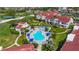 Aerial view of a community pool surrounded by well-maintained landscaping and white condos with red roofs at 6059 Bahia Del Mar Blvd # 235, St Petersburg, FL 33715