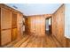 Bedroom featuring wood walls, hardwood floors, and closet at 6423 Bass Rd, Weeki Wachee, FL 34607