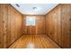 Empty room with wood paneled walls and floors, with a single window at 6423 Bass Rd, Weeki Wachee, FL 34607