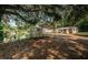 Exterior view of a waterfront property featuring a shelter, storage unit, house and waterway at 6423 Bass Rd, Weeki Wachee, FL 34607