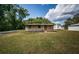 Single-story home with a well-kept lawn, and a neatly paved front entrance at 6423 Bass Rd, Weeki Wachee, FL 34607