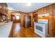 Kitchen featuring wood walls, hardwood floors, and an oven at 6423 Bass Rd, Weeki Wachee, FL 34607
