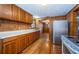 Kitchen featuring wood walls, hardwood floors, and stainless steel appliances at 6423 Bass Rd, Weeki Wachee, FL 34607