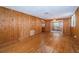 Living room featuring wood walls, hardwood floors, and sliding glass doors at 6423 Bass Rd, Weeki Wachee, FL 34607