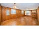 Living room featuring wood walls, hardwood floors, and natural lighting at 6423 Bass Rd, Weeki Wachee, FL 34607