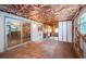 Renovated room with exposed insulation, wood paneling, and a sliding glass door at 6423 Bass Rd, Weeki Wachee, FL 34607