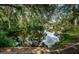 Scenic water view with lush green foliage, reflection of blue sky, in a peaceful residential neighborhood at 6423 Bass Rd, Weeki Wachee, FL 34607