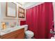 Functional bathroom with a vanity, toilet, and shower behind a privacy curtain at 6424 Ponder Dr, Port Richey, FL 34668