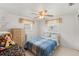 Bright bedroom featuring a comfortable bed, ceiling fan, and natural light at 6424 Ponder Dr, Port Richey, FL 34668