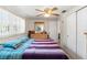 Bedroom featuring a bed, dresser, and closet with a ceiling fan overhead at 6424 Ponder Dr, Port Richey, FL 34668