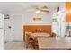The kitchen features wooden cabinets, a ceiling fan and views of the dining area at 6424 Ponder Dr, Port Richey, FL 34668