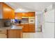 Bright kitchen features wooden cabinets, stone countertops, and modern appliances at 6424 Ponder Dr, Port Richey, FL 34668