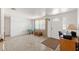 Bright living room with neutral tile flooring and a view of the front entrance at 6424 Ponder Dr, Port Richey, FL 34668
