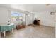 Bright living room with neutral tile flooring and a view of the front entrance at 6424 Ponder Dr, Port Richey, FL 34668