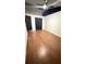 Bright bedroom with hardwood floors, ceiling fan, and large closet at 7017 Baywood Dr, Tampa, FL 33637
