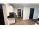 Bright kitchen with white cabinets, dark countertops, and wood-look floors at 7017 Baywood Dr, Tampa, FL 33637