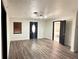 Open-concept living area with hardwood floors, fresh paint, and modern ceiling fan at 7017 Baywood Dr, Tampa, FL 33637