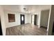 Bright living room featuring new flooring, a modern light fixture, and updated trim work at 7017 Baywood Dr, Tampa, FL 33637