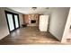 Spacious living room with a stone fireplace and wood-look floors at 7017 Baywood Dr, Tampa, FL 33637