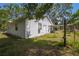 Exterior view of the home's rear showing the siding, windows, and a partially fenced yard at 7211 & 0 Sunnyside Dr, Brooksville, FL 34601