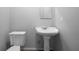 Quaint bathroom featuring a pedestal sink and toilet at 7211 & 0 Sunnyside Dr, Brooksville, FL 34601