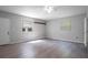 Spacious room with a door to outside, two large windows and laminate wood-style flooring at 7211 & 0 Sunnyside Dr, Brooksville, FL 34601