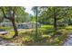 Exterior shot of home with fenced in yard and mature trees at 7211 & 0 Sunnyside Dr, Brooksville, FL 34601