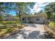 Single story home with mature trees, fenced in yard and driveway at 7211 & 0 Sunnyside Dr, Brooksville, FL 34601