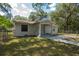 Single story home with mature trees, fenced in yard and driveway at 7211 & 0 Sunnyside Dr, Brooksville, FL 34601