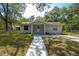 Charming single-story home with a well-maintained lawn, inviting walkway, and quaint front porch at 7211 & 0 Sunnyside Dr, Brooksville, FL 34601