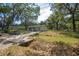 Single story home featuring a well-manicured lawn and mature trees in a desirable location at 7211 & 0 Sunnyside Dr, Brooksville, FL 34601
