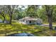 Aerial view of the home, showcasing its well-maintained lawn, fenced yard, and exterior at 7211 & 0 Sunnyside Dr, Brooksville, FL 34601