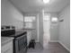 Clean kitchen with stainless steel oven and range, leading to a door into another room at 7211 & 0 Sunnyside Dr, Brooksville, FL 34601