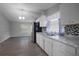 Well-lit kitchen with white cabinets, mosaic backsplash, and adjacent dining area, ready for modern updates at 7211 & 0 Sunnyside Dr, Brooksville, FL 34601