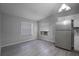Bright kitchen area features two windows providing natural light and a full-sized stainless steel refrigerator at 7211 & 0 Sunnyside Dr, Brooksville, FL 34601
