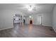 View of the open concept living room featuring light gray walls, light-colored flooring, and ceiling fan at 7211 & 0 Sunnyside Dr, Brooksville, FL 34601