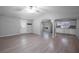 Open concept living room and kitchen featuring light gray walls, light-colored floors and white trim at 7211 & 0 Sunnyside Dr, Brooksville, FL 34601