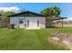 Spacious backyard featuring a covered area and an inviting fire pit, ideal for outdoor relaxation at 7494 7Th N St, St Petersburg, FL 33702