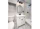 This bathroom features white vanity and a shower with stylish light tile and black hardware at 7494 7Th N St, St Petersburg, FL 33702
