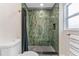 Bathroom featuring a dark shower with rainfall shower head, unique tiling, and modern fixtures at 7494 7Th N St, St Petersburg, FL 33702