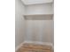 Walk-in closet with single shelf, hardwood floors, neutral paint, and simple design at 7494 7Th N St, St Petersburg, FL 33702