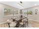 Dining room with plank flooring, natural light, decorative lighting, and contemporary accents at 7494 7Th N St, St Petersburg, FL 33702