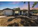 Inviting single-story home with a covered porch, white exterior, and well-manicured landscaping at 7494 7Th N St, St Petersburg, FL 33702