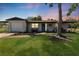 Charming single-story home featuring a well-manicured lawn, fresh landscaping, and inviting front porch at 7494 7Th N St, St Petersburg, FL 33702