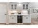 Kitchenette with white shaker cabinets, beverage fridge, modern fixtures, quartz countertops, and decorative backsplash at 7494 7Th N St, St Petersburg, FL 33702